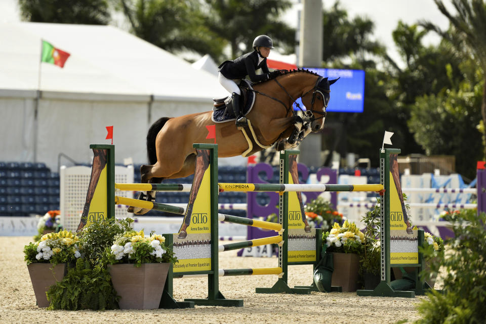 In this undated photo provided by KindMedia, Sophie Gochman on Dolores BH rides in the High Junior Jumpers at the Winter Equestrian Festival in Florida. Gochman wrote a recent blog that spelled out issues in show jumping, where she says white privilege and abundant wealth are the norm. It sparked a contentious debate within the equestrian world about how it deals with race, and how it is reacting to the calls for change that have come in the wake of George Floyd's death. (Annie Patterson/KindMedia via AP)