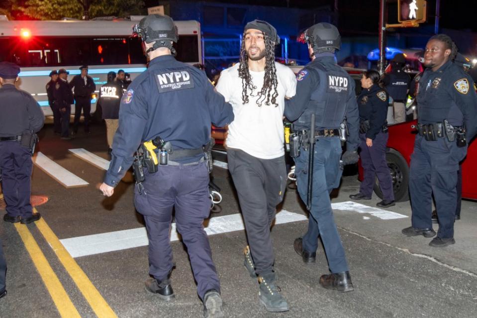 A protester is seen being arrested by NYPD officers at City College of New York in West Harlem on April 30, 2024. William Miller