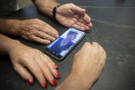 Moshe and Suzi Malinovitz video chat from their kitchen in Rehovot, Israel, with their daughter Ronit Malinovitz, from Phoenix, Ariz., Tuesday, July 27, 2021. While Ronit's parents were able to visit her in the Phoenix suburbs in the spring, she called off a trip to Israel this summer to see them and other relatives because of what she said was an overwhelming amount of paperwork involved in applying for Israeli passports for her two teenage daughters. (AP Photo/Maya Alleruzzo)