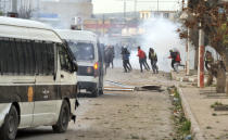 <p>Protesters run away from tear gas during anti-government protests, in Tebourba, south of the Tunisian capital, Tunis, Jan. 9, 2018. (Photo: Anis Ben Ali/AP) </p>