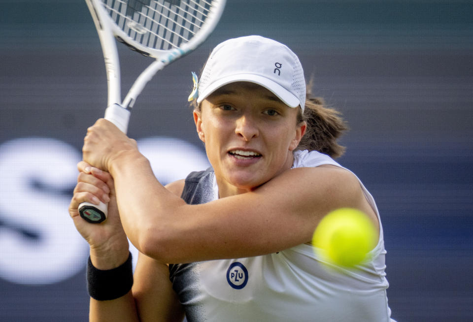 FILE - Poland's Iga Swiatek hits a backhand to Tatjana Maria, of Germany, during their first round WTA tour tennis match in Bad Homburg, Germany, Monday, June 26, 2023. Swiatek is expected to compete at Wimbledon next week. (AP Photo/Michael Probst, Fiule)