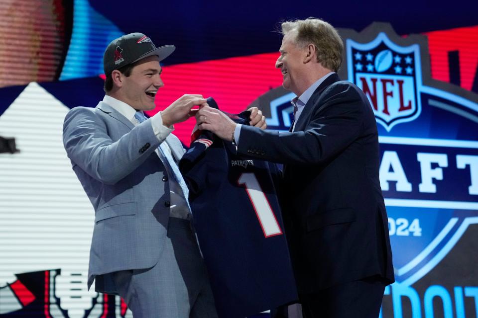 North Carolina quarterback Drake Maye, left, celebrates with NFL Commissioner Roger Goodell after being chosen by the New England Patriots with the third overall pick during the first round of the NFL football draft, Thursday, April 25, 2024, in Detroit. (AP Photo/Jeff Roberson)