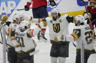 Vegas Golden Knights right wing Jonathan Marchessault (81) is congratulated by his teammates after scoring a goal during the second period of Game 3 of the NHL hockey Stanley Cup Finals against the Florida Panthers, Thursday, June 8, 2023, in Sunrise, Fla. (AP Photo/Rebecca Blackwell)