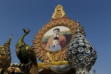 A picture showing Thailand's King Bhumibol Adulyadej and his son Crown Prince Vajiralongkorn as a child is seen on a street in Bangkok, Thailand April 17, 2016. REUTERS/Jorge Silva