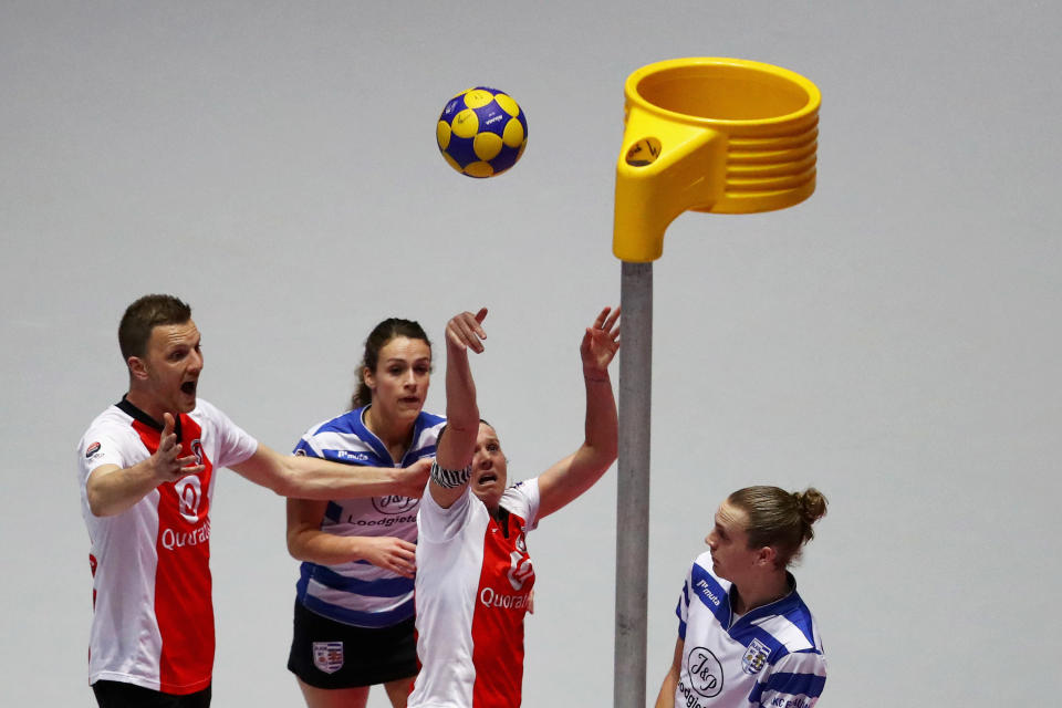 Korfball players shooting ball into basket