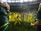 The boys blare out the team song in the middle of the MCG.