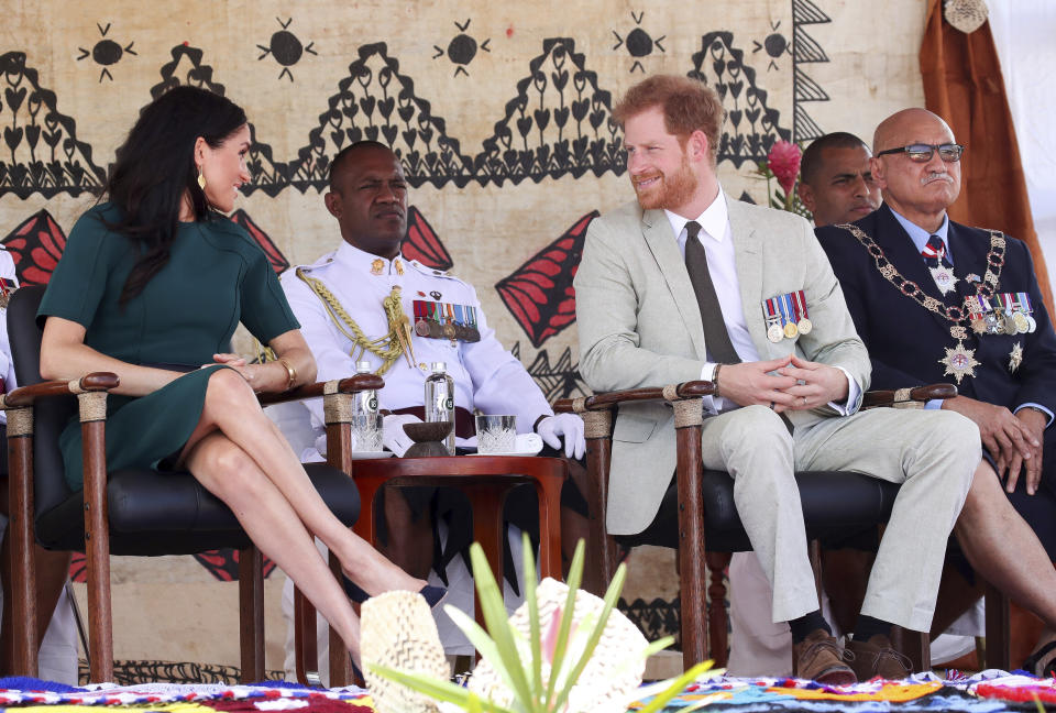 Britain's Prince Harry chats with his wife Meghan, Duchess of Sussex during an offical ceremony in Nadi, Fiji, Thursday, Oct. 25, 2018. Britain's Prince Harry and his wife Meghan are on day 10 of their 16-day tour of Australia and the South Pacific. (Chris Jackson/Pool Photo via AP)