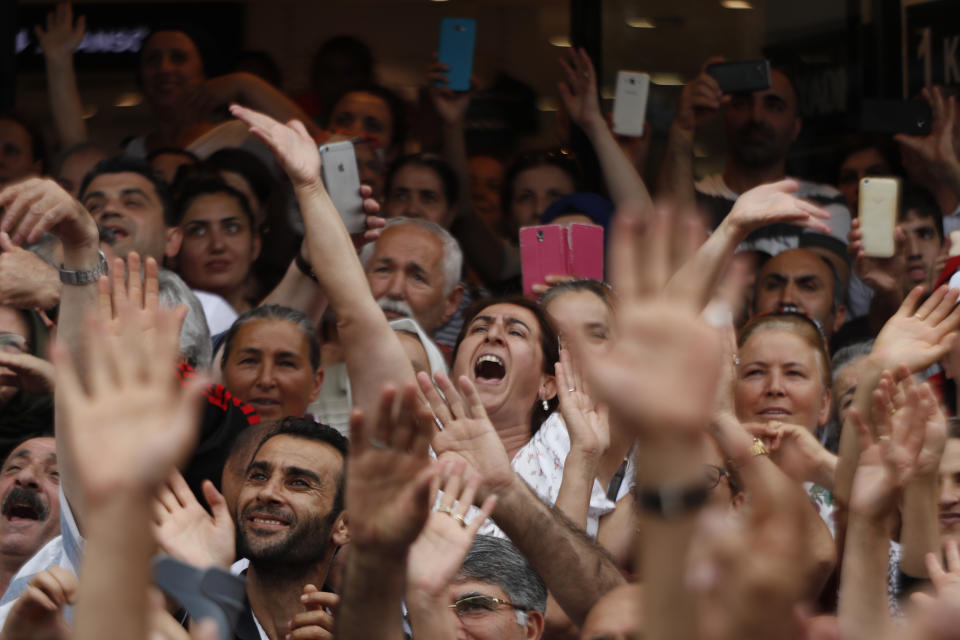 In this Wednesday, June 19, 2019 photo, supporters of Ekrem Imamoglu, candidate of the secular opposition Republican People's Party, or CHP, cheer as he speaks at a rally in Istanbul, ahead of the June 23 re-run of Istanbul elections. Millions of voters in Istanbul go back to the polls for a controversial mayoral election re-run Sunday, as President Recep Tayyip Erdogan's party tries to wrest back control of Turkey's largest city. (AP Photo/Lefteris Pitarakis)