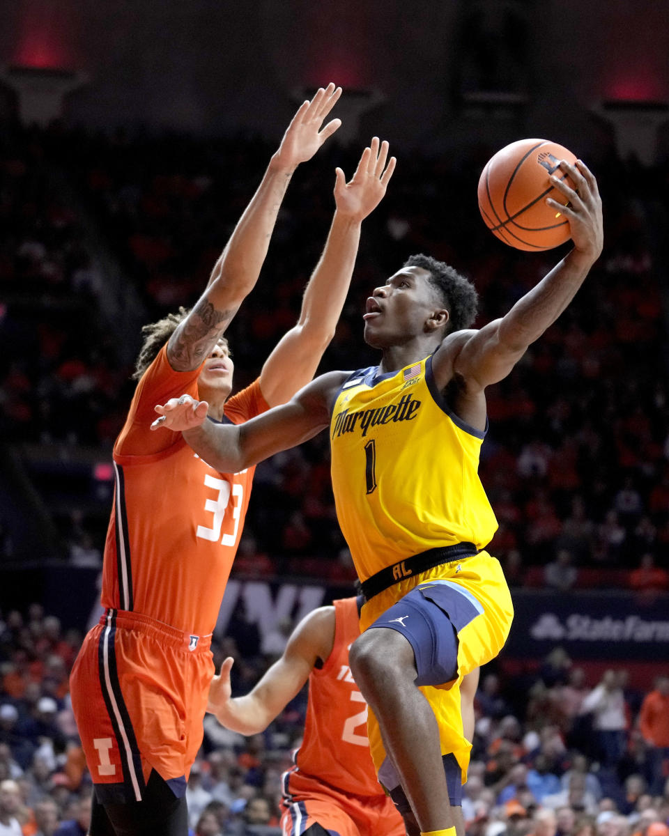 Marquette guard Kam Jones (1) shoots as Illinois forward Coleman Hawkins defends during the second half of an NCAA college basketball game Tuesday, Nov. 14, 2023, in Champaign, Ill. (AP Photo/Charles Rex Arbogast)