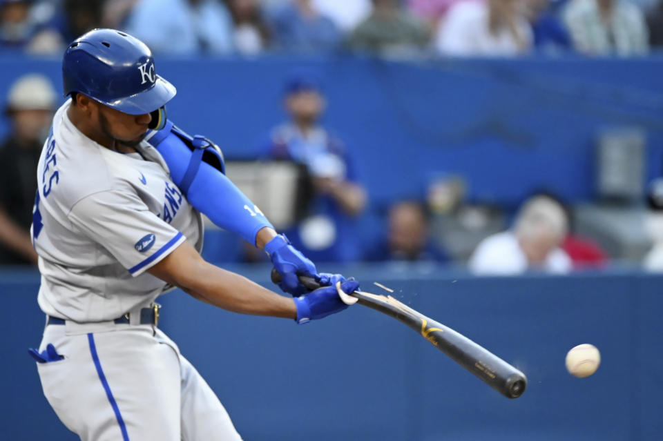 Kansas City Royals' Edward Olivares hits a broken-bat single off Toronto Blue Jays starting pitcher Kevin Gausman during the first inning of a baseball game Thursday, July 14, 2022, in Toronto. (Jon Blacker/The Canadian Press via AP)