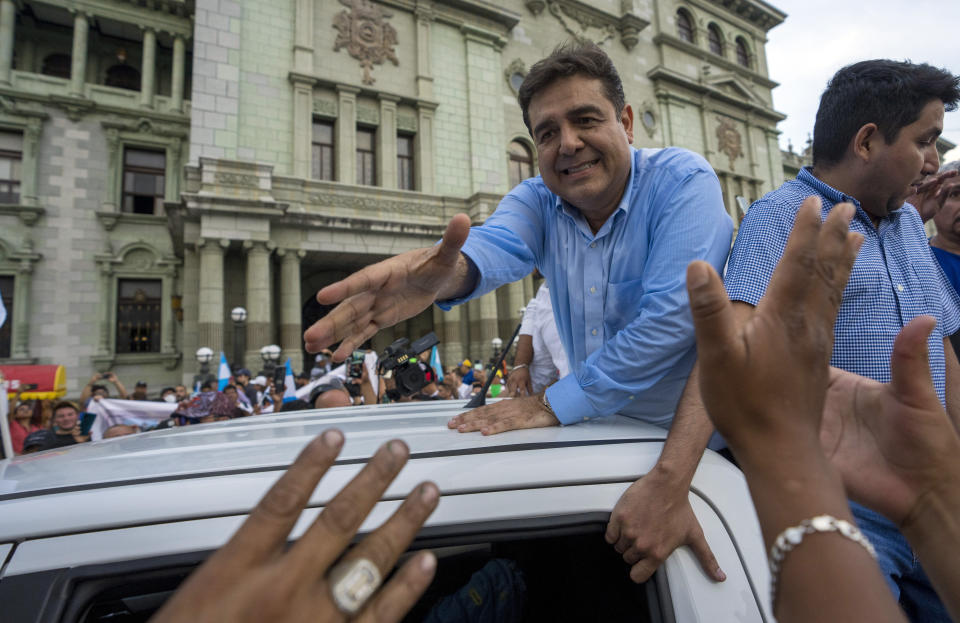 Presidential candidate Carlos Pineda, of the Prosperidad Ciudadana party, greats supporters after leaving the Constitutional Court in Guatemala City, Saturday, May 20, 2023. Pineda seeks to reverse a court decision that has excluded him from the electoral process. (AP Photo/Moises Castillo)