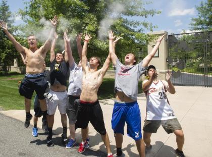 Cavaliers fans celebrate in front of the house of LeBron James. (AP)