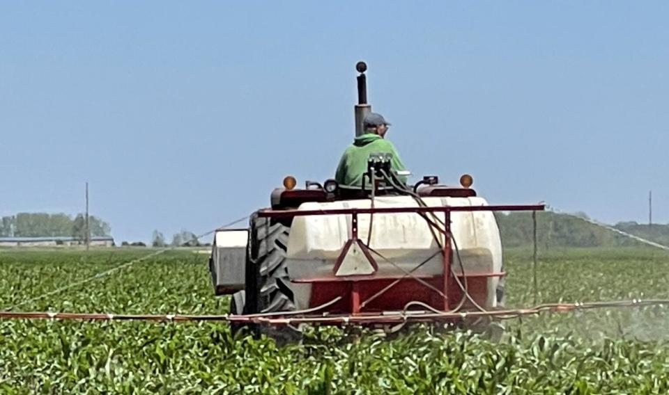 A farmer sprays his corn crop on the outskirts of Lennox, just southwest of Sioux Falls, on June 20. Ag groups across South Dakota have opposed a new bill aimed against foreign ag land purchases in the state.