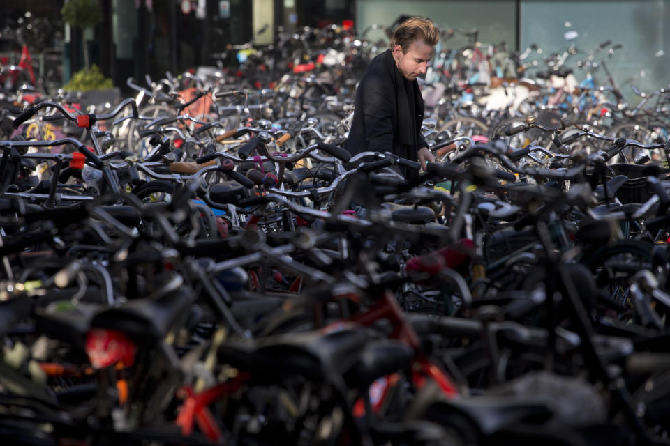 A man parks his bicycle near Central Station in Amsterdam, Netherlands, Wednesday Oct. 31, 2012. (AP Photo/Peter Dejong)