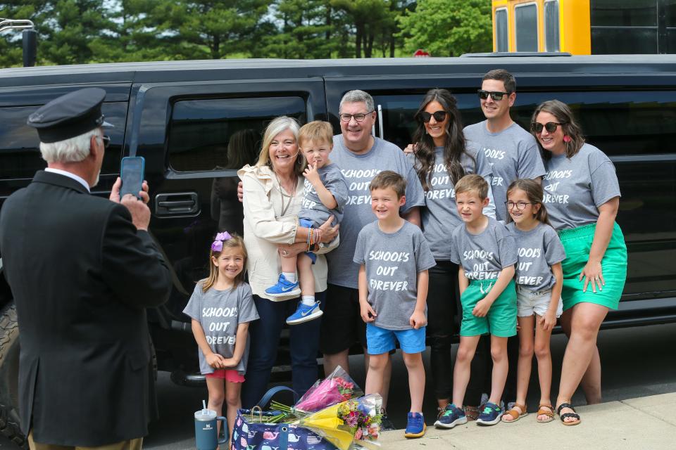 Kelly Curtis, first grade teacher at James Cole Elementary school, poses for a photo with her family before leaving the school in a limo on her last day of her academic career, on Thursday, May 25, 2023, in Lafayette, Ind.