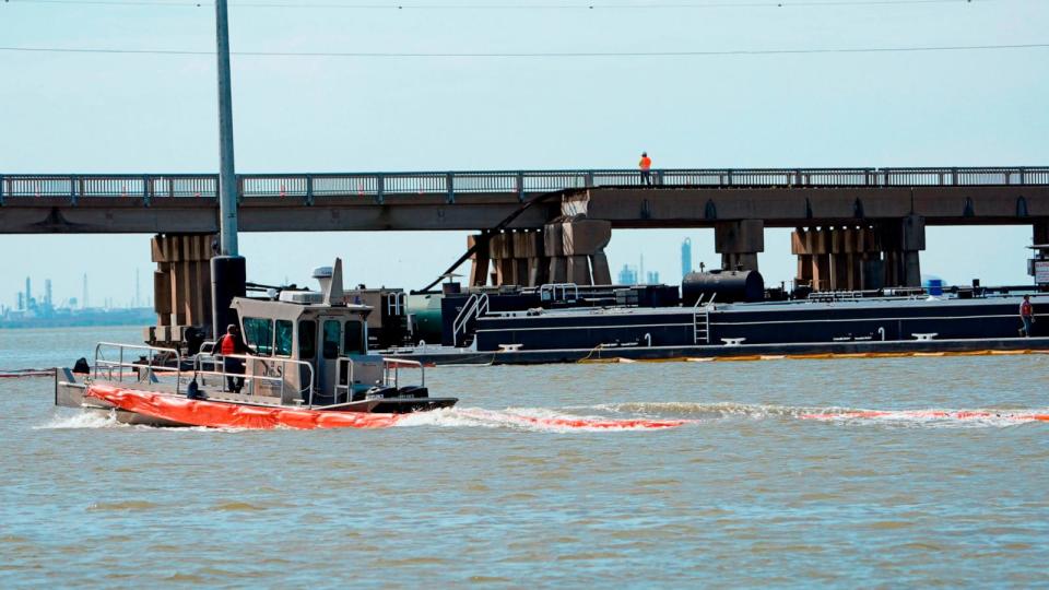 PHOTO: An spill boom is moved into position to contain a leak from a barge that crashed into the Pelican Island Bridge, May 15, 2024, in Galvestobn, Texas. (David J. Phillip/AP)