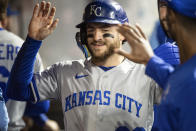 Kansas City Royals' Kyle Isbel is congratulated in the dugout after scoring on a double by MJ Melendez during the fourth inning of a baseball game against the Cleveland Guardians in Cleveland, Saturday, Oct. 1, 2022. Isbel drove in two runs earlier in the inning. (AP Photo/Phil Long)