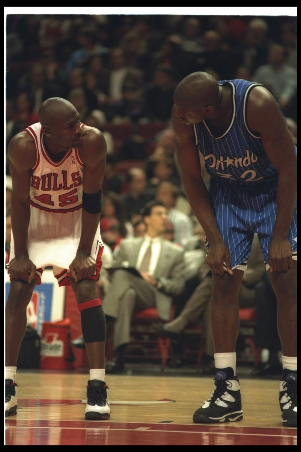 Shaquille O'Neal and Chicago Bulls guard Michael Jordan confer during a game at the United Center in Chicago, Illinois on March 24, 1995. (Allsport)