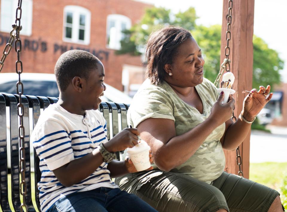 Malachi Taylor and his mom, Melissa Bailey-Taylor enjoy an ice cream cones from Ice Cream Station in downtown Simpsonville, Friday April, 29, 2022. 