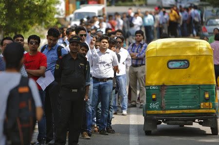 People stand in a queue outside the venue to attend the launch ceremony of Xiaomi's Mi 4i phone in New Delhi April 23, 2015. REUTERS/Anindito Mukherjee