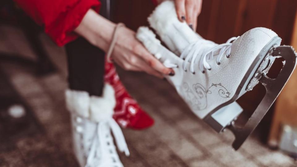 Person putting on ice skates