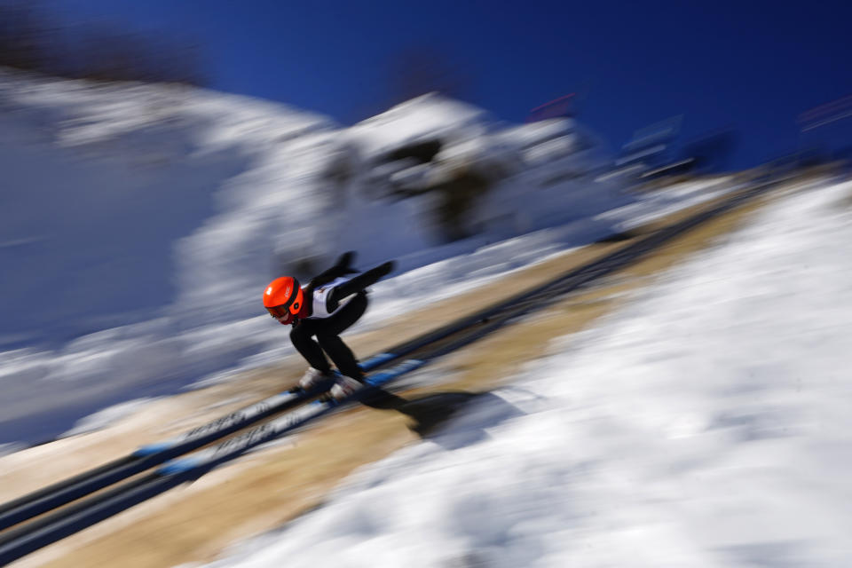 Islay Sheil, 14, of Lakeville, Conn., speeds down a 39-meter jump during the Eastern Ski Jumping Meet, Sunday, Jan. 21, 2024, in Milan, N.H. (AP Photo/Robert F. Bukaty)