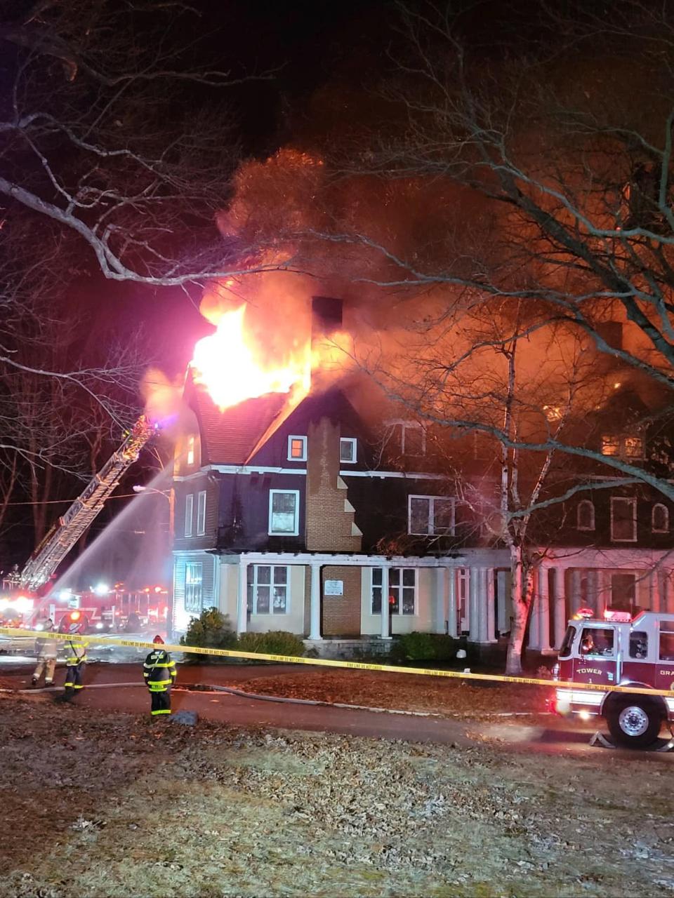 Flames tore through the roof of the mansion.