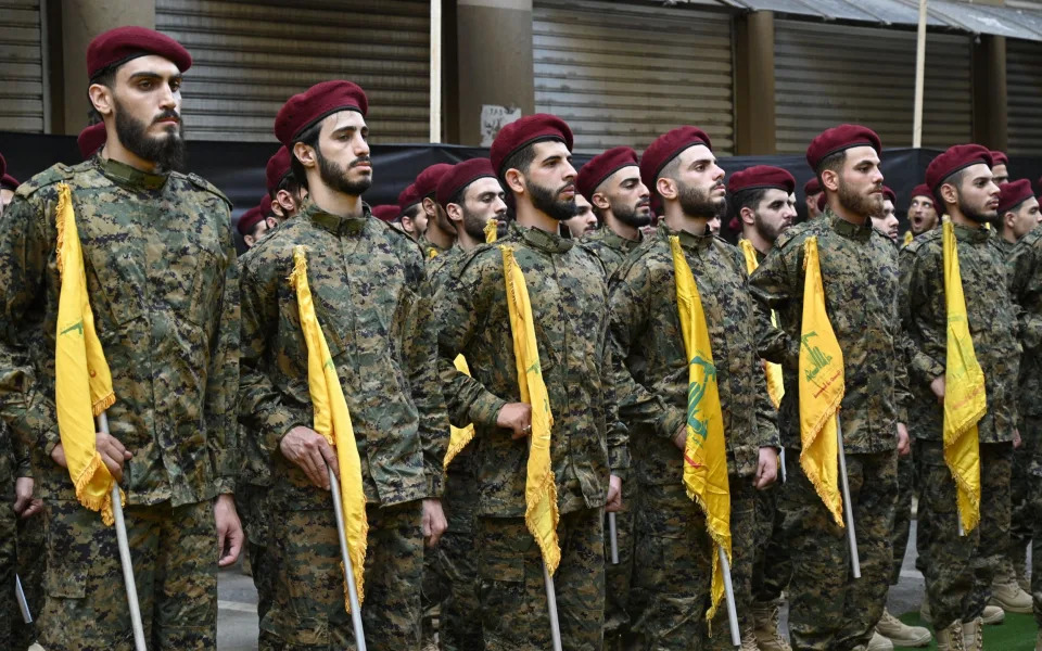 Hezbollah fighters attend the funeral of two commanders killed in an Israeli strike