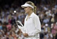 Eugenie Bouchard of Canada holds the runner up trophy after being defeated by Petra Kvitova of Czech Republic at their women's singles final tennis match at the Wimbledon Tennis Championships in London July 5, 2014. REUTERS/Toby Melville