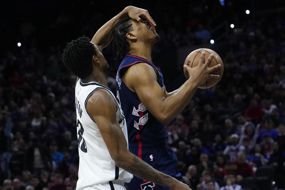 Philadelphia 76ers' Jaden Springer, right, is fouled by Brooklyn Nets' Nic Claxton during the first half of an NBA basketball game, Saturday, Feb. 3, 2024, in Philadelphia. (AP Photo/Matt Slocum)