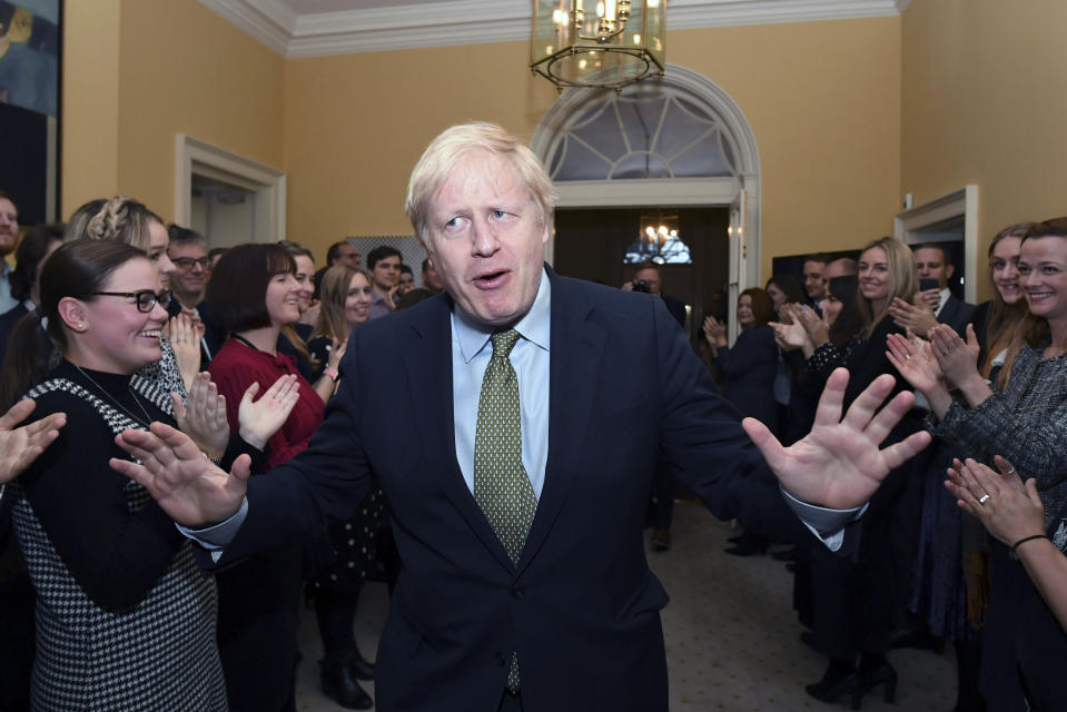 FILE - Britain's Prime Minister Boris Johnson is greeted by staff as he returns to 10 Downing Street, London, after meeting Queen Elizabeth II at Buckingham Palace and accepting her invitation to form a new government Friday Dec. 13, 2019. British media say Prime Minister Boris Johnson has agreed to resign on Thursday, July 7 2022, ending an unprecedented political crisis over his future. (Stefan Rousseau/PA via AP, File)