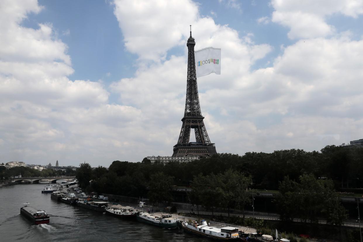 In this June 8, 2021, file photo, a giant flag flies at the Eiffel Tower in Paris. (AP Photo/Lewis Joly, File)