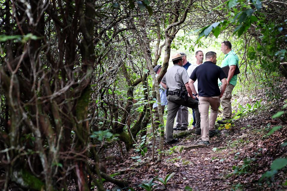 National Park Service and other federal Investigators investigate a crime scene on the Blue Ridge Parkway in July 2018 where a woman's body was found. The park in North Carolina and Virginia receives 14.7 million visitors a year and had 20 fatalities in 2018. It will send up to three law enforcement rangers on details to the U.S.-Mexican border in the next six months.