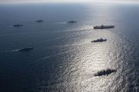 FILE - U.S. aircraft carrier USS Ronald Reagan, top right, participates with other U.S. and South Korean navy ships during the joint naval exercises between the United States and South Korea in waters off South Korea's eastern coast in South Korea, on Sept. 29, 2022. South Korea, U.S. and Japanese warships launched their first anti-submarine drills in five years on Friday, Sept. 30, after North renewed ballistic missile tests this week in an apparent response to bilateral training by South Korean and U.S. forces.(South Korea Navy/Yonhap via AP, File)