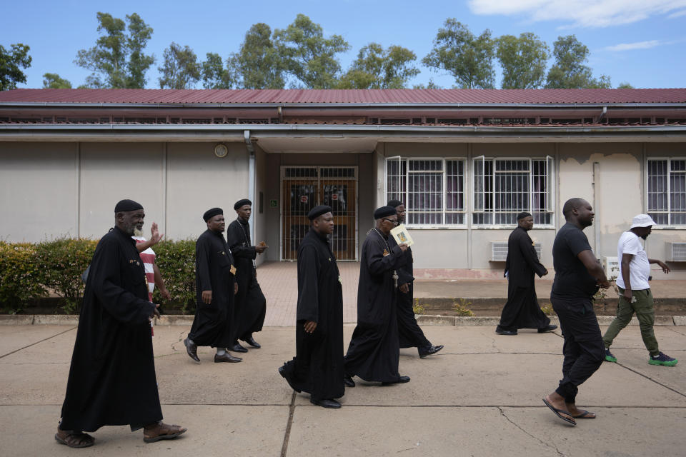 Members of the Saint Mark the Apostle and Saint Samuel the Confessor Monastery arrive at the magistrate court in Cullinan, a town east of Pretoria, South Africa, Thursday, March 14, 2024. Two suspects appeared at the court for the murder of three Egyptian monks belonging to the Coptic Orthodox Church at a monastery in South Africa. (AP Photo/Themba Hadebe)