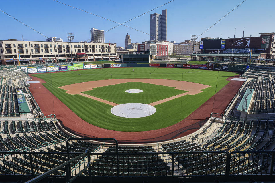 FILE - In this April 8, 2020, file photo, an empty Parkview Field minor league baseball stadium is viewed in downtown Fort Wayne, Ind. Minor league umpires are out of jobs so far and maybe all year with no minor league seasons due to the coronavirus pandemic. (Mike Moore/The Journal-Gazette via AP, File)