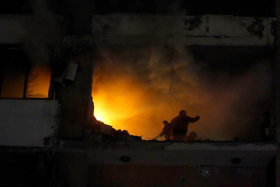 People search for survivors inside an apartment following a massive explosion in the southern Beirut suburb of Dahiyeh, Lebanon, Tuesday, Jan. 2, 2024. An explosion killed Saleh Arouri, a top official with the Palestinian militant group Hamas and three others, officials with Hamas and the Lebanese group Hezbollah said. (AP Photo/Bilal Hussein)