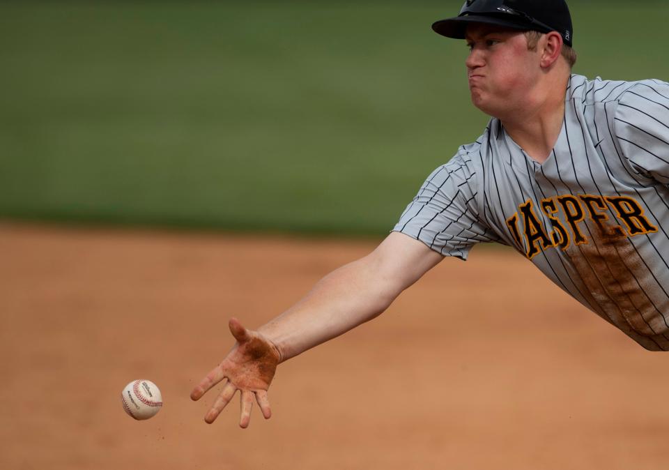 Jasper's Chris Hedinger (16) flips the ball to his pitcher to get the Memorial runner out at first base at Memorial's Stone Field Monday afternoon, May 2, 2022.