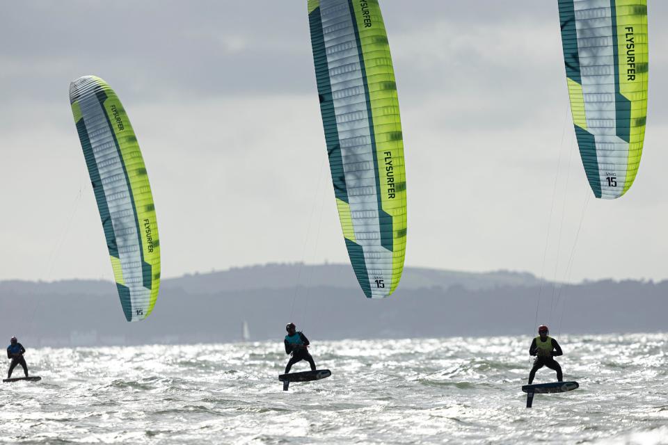 Pictures of a fleet racing on September 24, 2023 in Portsmouth, England. An athlete who completed in kite foiling, J.J. Rice, died on June 15, 2024 in a diving accident in Tonga. He was 18.