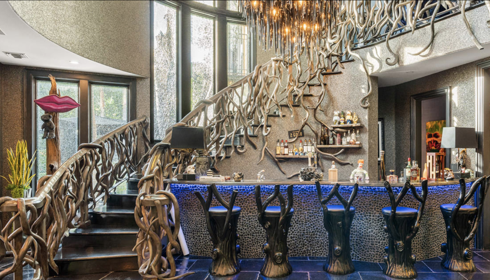 The interior of the McGraw property features bespoke details, such as branches on the stair railing and twigs on the back of the chairs at the bar. (Photo: Billy Dolan of Hilton & Hyland)