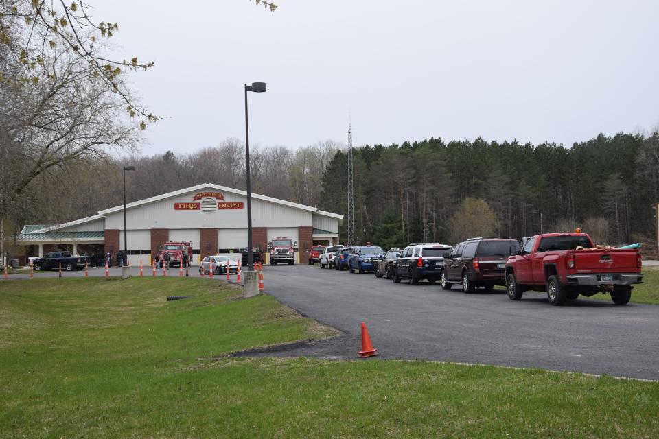 Cars line up at the Alanson Fire Station so families can be reunited with their students after a report of a firearm was made at the Alanson Public School on Thursday, April 27, 2023.