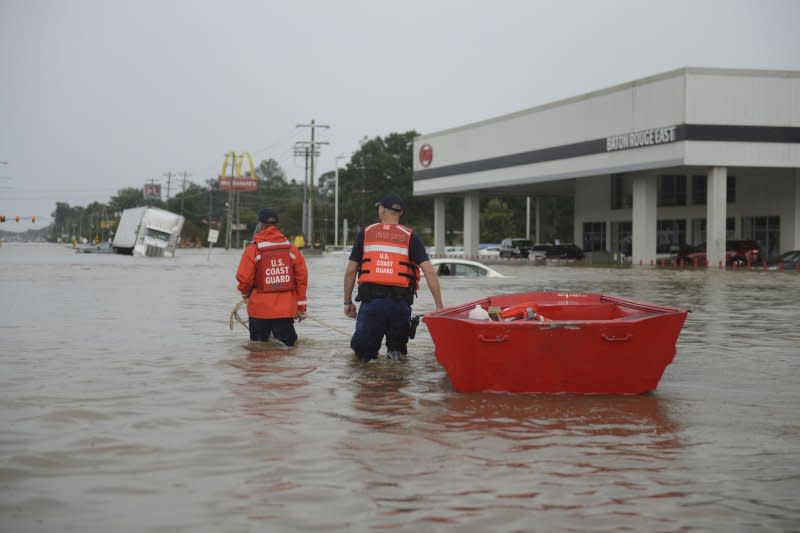 Members of the U.S. Coast Guard head into the water with their flat-bottom boats to assist locals during the flooding in Baton Rouge, La., on August 14, 2016. On August 17, 2016, the flooding had killed 13 people, and left thousands of people in shelters and seeking aid. File Photo by Brandon Giles/U.S. Coast Guard/UPI