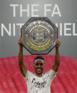 Arsenal's Pierre-Emerick Aubameyang lifts the trophy after winning the English FA Community Shield soccer match between Arsenal and Liverpool at Wembley stadium in London, Saturday, Aug. 29, 2020. (Andrew Couldridge/Pool via AP)