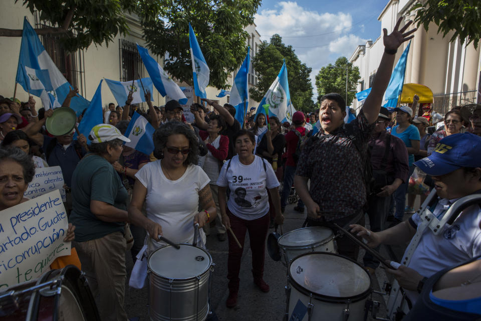 Demonstrators protest against Guatemalan President Jimmy Morales during a demonstration organized by civil society groups in front of the Presidential House in Guatemala City, Saturday, July 27, 2019. (AP Photo/ Oliver de Ros)