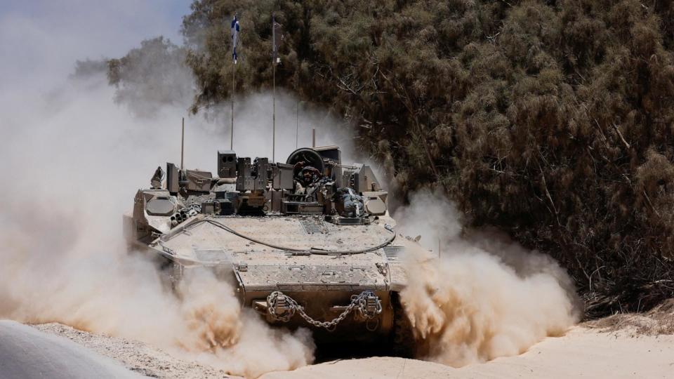PHOTO: An Israeli military vehicle maneuvers near the Israel-Gaza border (Amir Cohen/Reuters)