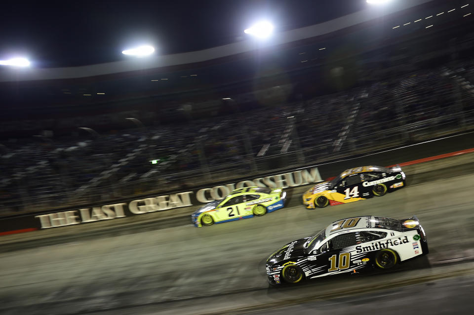 BRISTOL, TENNESSEE - SEPTEMBER 19: Aric Almirola, driver of the #10 Smithfield Ford, Matt DiBenedetto, driver of the #21 Menards/Dutch Boy Ford, and Clint Bowyer, driver of the #14 Rush Truck Centers/Cummins Ford, race during the NASCAR Cup Series Bass Pro Shops Night Race at Bristol Motor Speedway on September 19, 2020 in Bristol, Tennessee. (Photo by Jared C. Tilton/Getty Images)