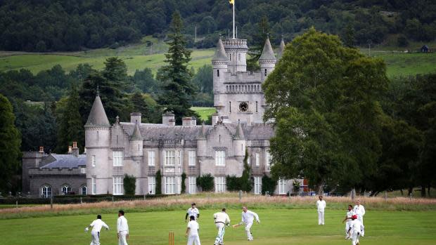 HeraldScotland: Balmoral Castle forms the backdrop to a game of circket