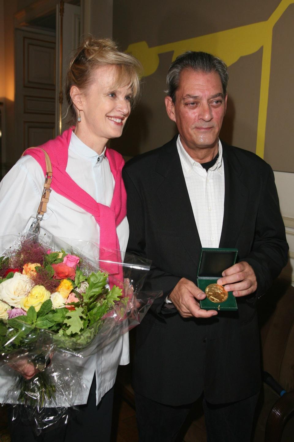 Auster with his wife the writer Siri Hustvedt during an award ceremony after he received the Grand Vermeil medal from the mayor of Paris in 2010