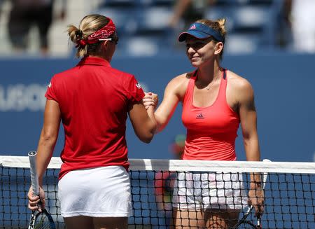 Aug 30, 2016; New York, NY, USA; Simona Halep of Romania greets Kirsten Flipkens of Belgium after their match on day two of the 2016 U.S. Open tennis tournament at USTA Billie Jean King National Tennis Center. Mandatory Credit: Jerry Lai-USA TODAY Sports