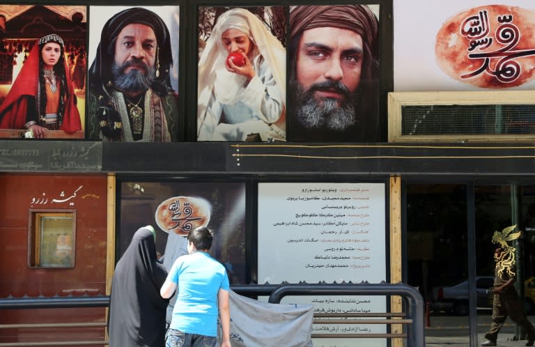 Iranians stand in front of a cinema featuring "Muhammad" in Tehran on August 27, 2015 -- the first day of screening